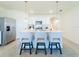 Bright kitchen with modern appliances, island with bar stools, and tile flooring at 33488 Elm Hill Br, Wesley Chapel, FL 33545