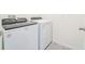 Well-lit laundry room featuring modern Whirlpool washing machine and dryer appliances for added convenience at 33488 Elm Hill Br, Wesley Chapel, FL 33545