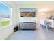Open-concept living space with a large window, contemporary decor, and a modern entertainment center at 33488 Elm Hill Br, Wesley Chapel, FL 33545