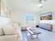 Comfortable living room with a plush sofa, stylish coffee table, and modern entertainment center at 33488 Elm Hill Br, Wesley Chapel, FL 33545
