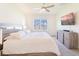 Serene main bedroom features a ceiling fan, window view, and sleek furniture at 33488 Elm Hill Br, Wesley Chapel, FL 33545