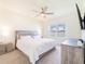 Tranquil main bedroom with a ceiling fan, window, and stylish modern furniture at 33488 Elm Hill Br, Wesley Chapel, FL 33545
