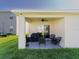 This covered patio is perfect for grilling and features a ceiling fan and plenty of room for entertaining at 33488 Elm Hill Br, Wesley Chapel, FL 33545