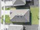 Aerial view of a roof surrounded by a green yard and neighborhood at 33488 Elm Hill Br, Wesley Chapel, FL 33545