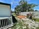 Backyard area with wooden patio, landscaping and partial fencing at 34041 Azalea N Dr, Pinellas Park, FL 33781