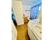 Bathroom featuring a double vanity with marble countertops, tile flooring, and a separated toilet and shower area at 34041 Azalea N Dr, Pinellas Park, FL 33781