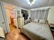 Cozy bedroom featuring a comfortable bed, closet, and ensuite bathroom for added convenience at 34041 Azalea N Dr, Pinellas Park, FL 33781