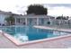 Inviting community pool surrounded by lounge chairs, landscaped grounds, and a view of the clubhouse at 34041 Azalea N Dr, Pinellas Park, FL 33781