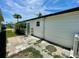 Side of the mobile home with a small garden area and a concrete patio at 34041 Azalea N Dr, Pinellas Park, FL 33781