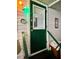 Exterior shot of a charming green front door with glass window and white trim at 34041 Azalea N Dr, Pinellas Park, FL 33781