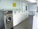 Clean and functional laundry room equipped with multiple washing machines for residents' convenience at 34041 Azalea N Dr, Pinellas Park, FL 33781