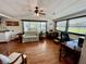 Cozy living room featuring a comfortable couch, dining table, and an office space with natural light from the window at 34041 Azalea N Dr, Pinellas Park, FL 33781