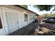 Home exterior featuring concrete patio, white siding, and weathered details, ideal for renovation and personalization at 3424 16Th E St, Bradenton, FL 34208