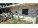 Exterior view of a side of a home with a window, hoses, and other items at 3424 16Th E St, Bradenton, FL 34208