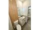 Bathroom featuring toilet, wood paneling, granite countertop, and glass enclosed shower at 3504 Crooked River Dr, Plant City, FL 33565