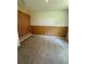 Bedroom featuring modern wood paneling, carpet, and an electrical outlet at 3504 Crooked River Dr, Plant City, FL 33565