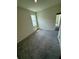 This carpeted bedroom features a window providing natural light and an open doorway at 3504 Crooked River Dr, Plant City, FL 33565