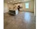 Open-concept kitchen featuring granite countertops, an island, and ample cabinet space at 3504 Crooked River Dr, Plant City, FL 33565