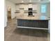 Well-equipped kitchen with an island, granite countertops, modern appliances, and stylish cabinetry at 3504 Crooked River Dr, Plant City, FL 33565