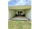 Covered patio offers relaxing view of the expansive lawn with sliding glass door access at 3504 Crooked River Dr, Plant City, FL 33565