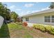Well-maintained backyard featuring lush lawn, landscaping, and a patio area for outdoor enjoyment at 3966 High Bluff Dr, Largo, FL 33770