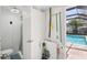 Bathroom and storage area leading to the screened-in pool deck at 3966 High Bluff Dr, Largo, FL 33770