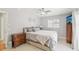 This bedroom features neutral walls, a ceiling fan, a large window, and a comfortable bed at 3966 High Bluff Dr, Largo, FL 33770