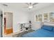 Well lit bedroom featuring a ceiling fan, neutral walls, and a built in desk and storage unit at 3966 High Bluff Dr, Largo, FL 33770