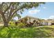 Well-maintained home showcasing a manicured lawn, vibrant landscaping, walkway, and an attached two-car garage at 3966 High Bluff Dr, Largo, FL 33770