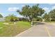 Charming single-story home on a well-maintained lawn with mature trees and lush landscaping at 3966 High Bluff Dr, Largo, FL 33770