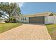 Inviting single-story home showcasing a well-manicured lawn, landscaped garden beds and driveway at 3966 High Bluff Dr, Largo, FL 33770