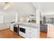 Open-concept kitchen boasting stainless steel appliances, stone countertops, and seamless flow into living area at 3966 High Bluff Dr, Largo, FL 33770