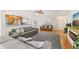 Bright, open-concept living area with hardwood floors seamlessly connects the kitchen, dining, and living spaces at 3966 High Bluff Dr, Largo, FL 33770