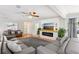 Inviting living room featuring a cozy fireplace, ample seating, modern ceiling fan, and plenty of natural light at 3966 High Bluff Dr, Largo, FL 33770