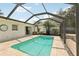 Relaxing pool inside screened lanai with brick pavers at 3966 High Bluff Dr, Largo, FL 33770