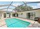 The beautiful pool inside the screened lanai is perfect for Florida lifestyle at 3966 High Bluff Dr, Largo, FL 33770