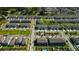 An aerial view of a neighborhood with manicured lawns and townhomes near the water at 4023 Wild Senna Blvd, Tampa, FL 33619