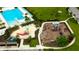 A community playground and pool with palm trees, lounge chairs, and a splash pad at 4023 Wild Senna Blvd, Tampa, FL 33619