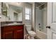Well-lit bathroom features a granite-topped vanity, toilet, shower/tub combo, and tiled flooring at 4023 Wild Senna Blvd, Tampa, FL 33619