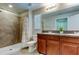 Bathroom with tile shower, granite countertop, double sink vanity, lighting, and toilet at 4023 Wild Senna Blvd, Tampa, FL 33619