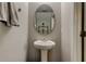 Small bathroom featuring a pedestal sink, oval mirror, and towel rack at 4023 Wild Senna Blvd, Tampa, FL 33619