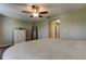 A bedroom features carpet and a ceiling fan, with a view into the hallway at 4023 Wild Senna Blvd, Tampa, FL 33619