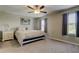 Neutral bedroom featuring carpet, a ceiling fan, and windows at 4023 Wild Senna Blvd, Tampa, FL 33619