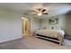 A bright bedroom with carpet, a ceiling fan, and a neutral color scheme at 4023 Wild Senna Blvd, Tampa, FL 33619