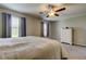 Bedroom with carpet, ceiling fan, two windows with curtains, and chest of drawers at 4023 Wild Senna Blvd, Tampa, FL 33619