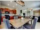 View of the kitchen and dining room with wooden table, four upholstered chairs, and overhead lighting at 4023 Wild Senna Blvd, Tampa, FL 33619