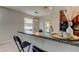 Open-concept kitchen with breakfast bar and view into the dining room at 4023 Wild Senna Blvd, Tampa, FL 33619