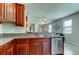 Open-concept kitchen featuring stainless steel dishwasher, stainless steel sink, and granite countertops at 4023 Wild Senna Blvd, Tampa, FL 33619