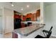 Kitchen with dark cabinets, black appliances and granite countertops at 4023 Wild Senna Blvd, Tampa, FL 33619