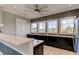 Clubhouse kitchenette with granite countertops and black cabinetry at 4023 Wild Senna Blvd, Tampa, FL 33619